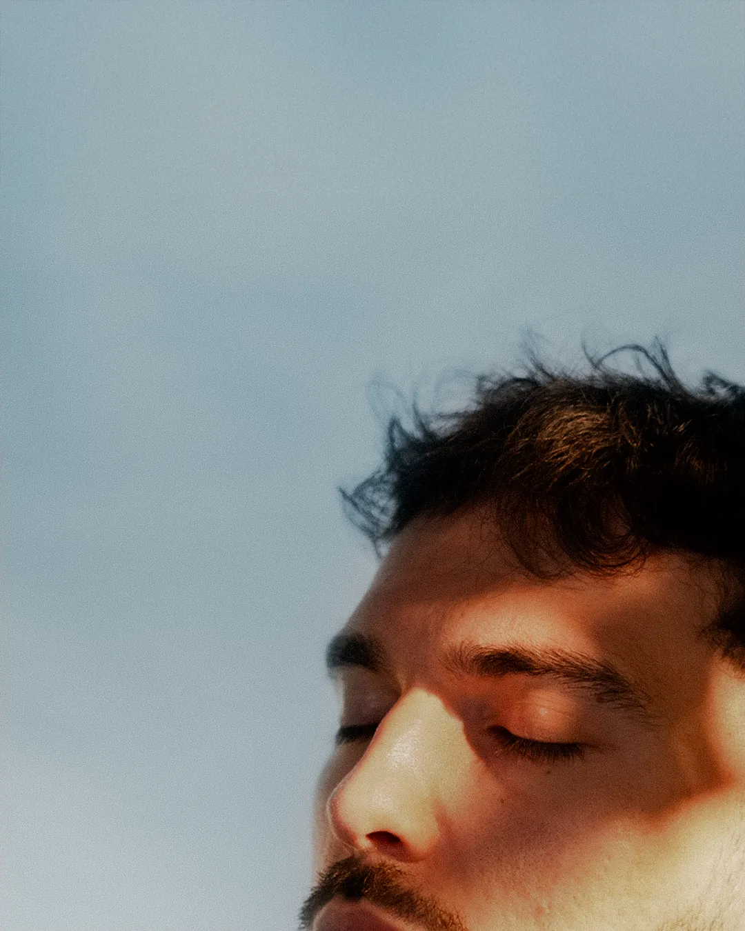 Portrait rapproché, yeux fermés au soleil