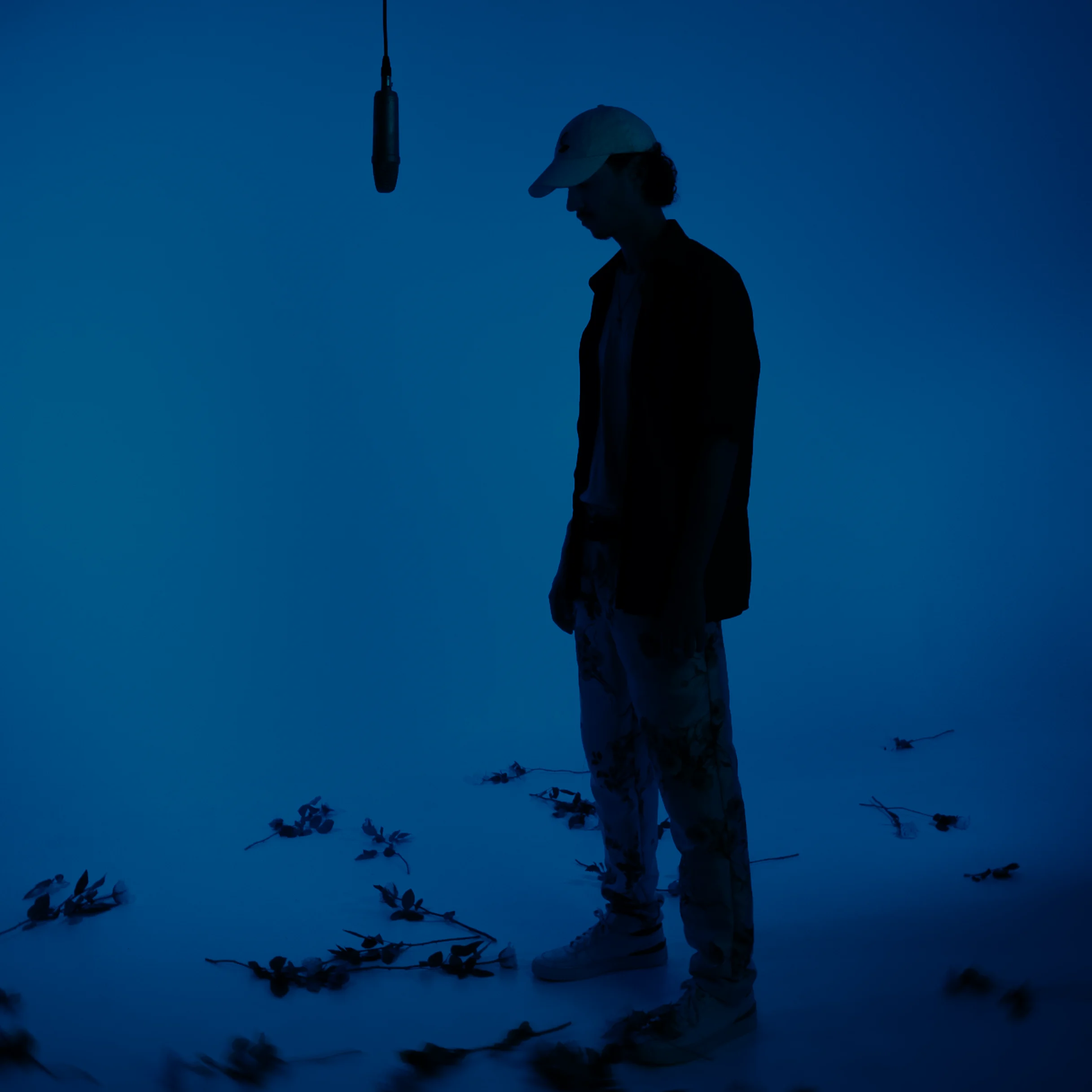 Silhouette sous un micro dans une lumière bleue